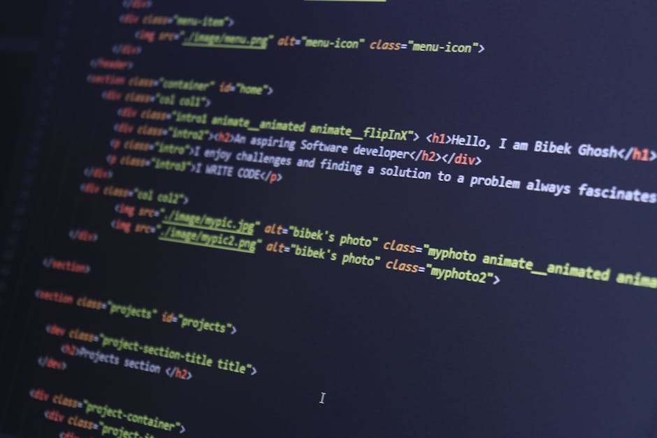 Photograph of a computer screen displaying lines of colorful programming code on a dark background. The code includes various syntax elements such as functions, variables, conditional statements, and 